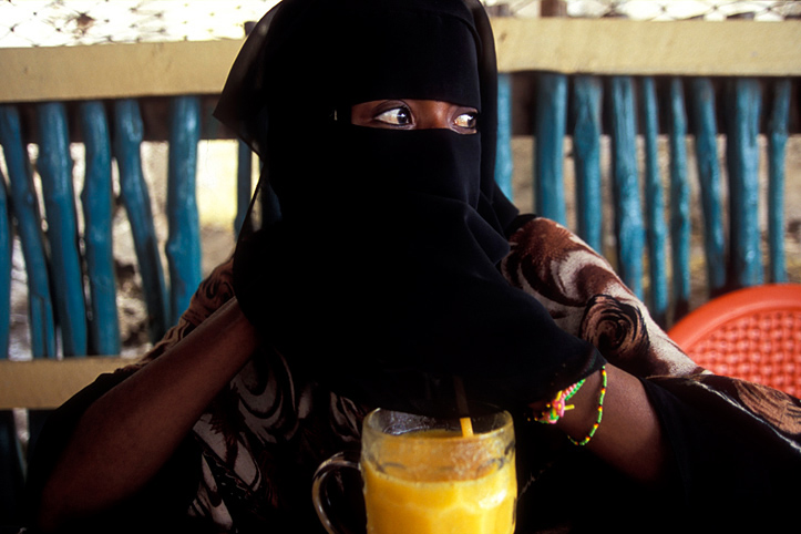 Kenya. Lamu. Woman in coffee shop